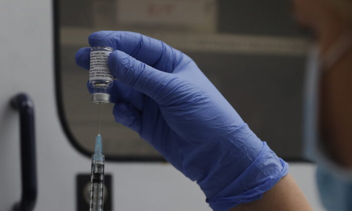 A vial of the Phase 3 Novavax coronavirus vaccine is seen ready for use in the trial at St. George's University hospital in London, Oct. 7, 2020. (AP Photo/Alastair Grant, File)