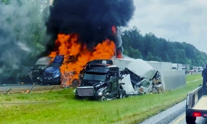  Flames and smoke billow from trucks involved in a deadly multiple vehicle crash along Interstate 30 in southwestern Ark. on June 8, 2022. (Joni Deardorff/AP Photo)