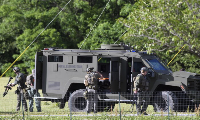 Tactical police work near where a man killed three people when he opened fire at a business in Smithsburg, Md., on June 9, 2022. (Steve Ruark/AP Photo)