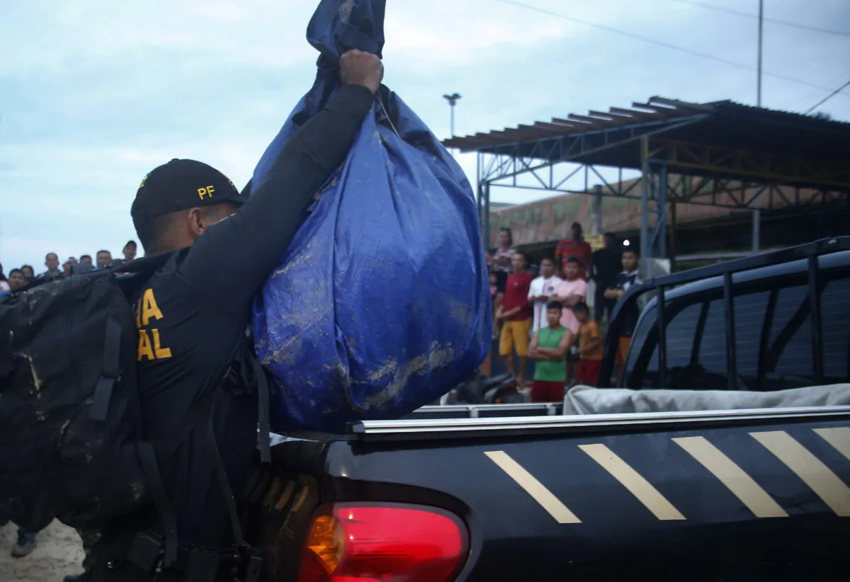 A Federal Police officer loads a truck with items found during a search for Indigenous expert Bruno Pereira and freelance British journalist Dom Phillips in Atalaia do Norte, Amazonas state, Brazil, on June 12, 2022. (Edmar Barros/AP Photo)