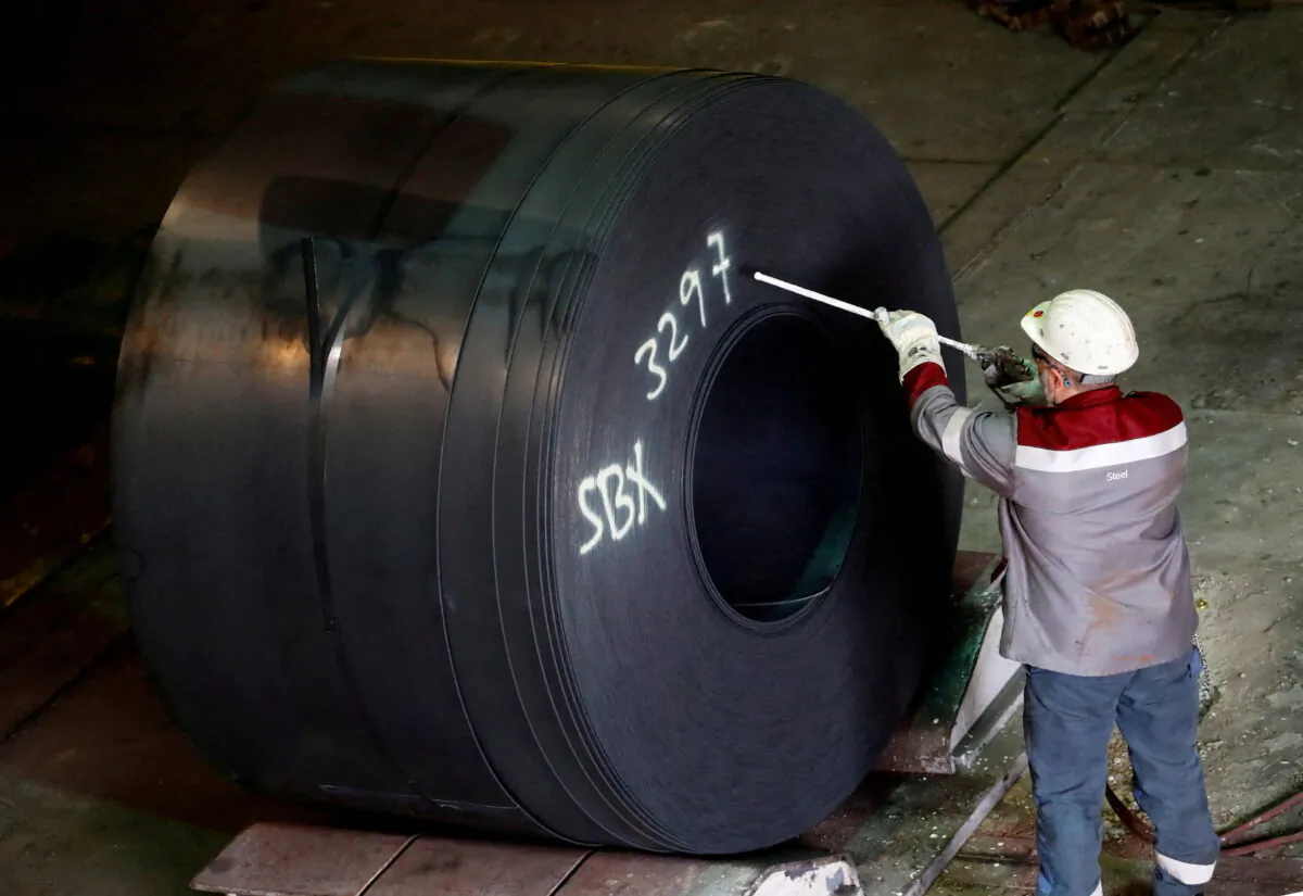 A steel coil receives its number by a worker at the ThyssenKrupp steel plant in Duisburg, Germany on Jan. 30, 2020. (Wolfgang Rattay/Reuters)