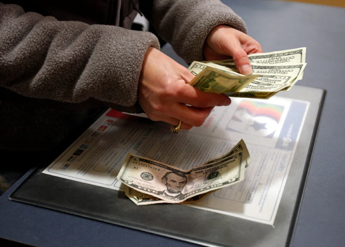 A customer counts her money at the register of a Toys R Us store on the Thanksgiving Day holiday in Manchester, N.H., on Nov. 22, 2012. (Jessica Rinaldi/Reuters)