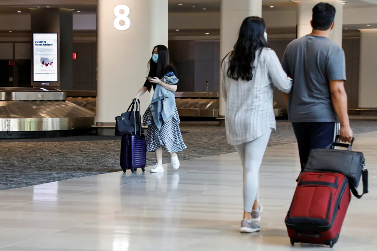 A sign alerts travelers to the danger of COVID-19 at LaGuardia Airport, during the outbreak of the coronavirus disease (COVID-19), in New York, on June 29, 2020. (Brendan McDermid/Reuters)