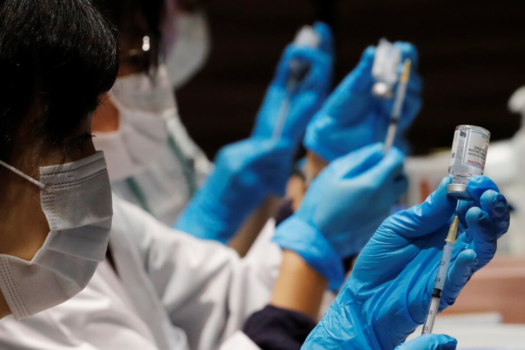 Healthcare workers prepare doses of the Moderna coronavirus disease (COVID-19) vaccine before administering them to staffers of Japan's supermarket group Aeon at the company's shopping mall in Chiba, Japan, on June 21, 2021. (Kim Kyung-Hoon/Reuters)