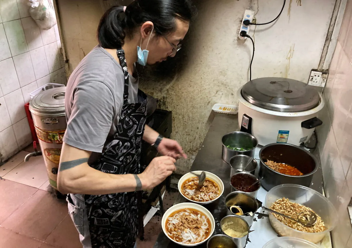 Noodles shop owner Wang Zongxing makes noodles for customers at his restaurant in Shenzhen, Guangdong province, China, on May 15, 2020. (Martin Pollard/Reuters)