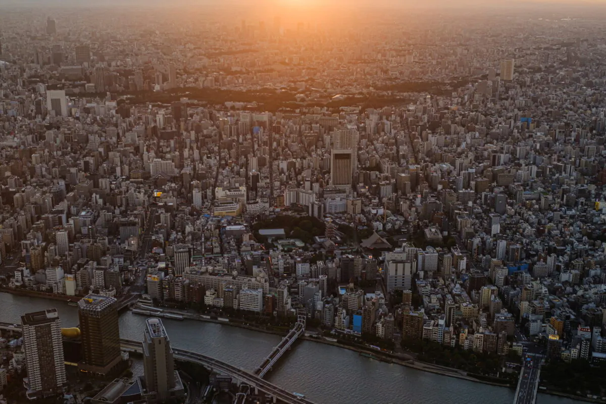 The sun sets over office and residential buildings seen from the observation deck of Tokyo Skytree, the world's tallest broadcasting tower, in Tokyo, Japan, on Aug. 18, 2021. (Marko Djurica/Reuters)