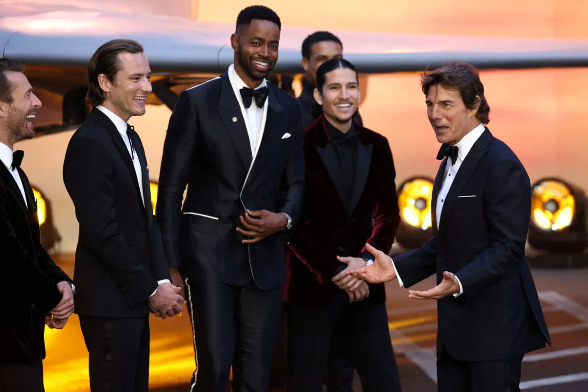Actor Tom Cruise reacts next to fellow cast and crew members during the premiere of 'Top Gun: Maverick' in London on May 19, 2022. (Henry Nicholls/Reuters)