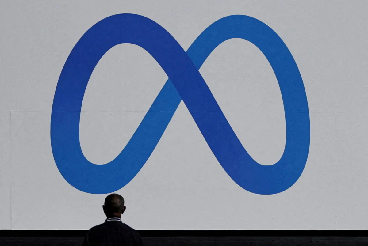 A man stands in front of a sign of Meta at its headquarters in Menlo Park, Calif. on Oct. 28, 2021. (Carlos Barria/Reuters)