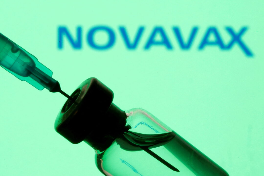 A vial and sryinge in front of a displayed Novavax logo on Jan.11, 2021. (Dado Ruvic/Illustration/Reuters)