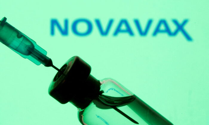 A vial and sryinge in front of a displayed Novavax logo on Jan.11, 2021. (Dado Ruvic/Illustration/Reuters)