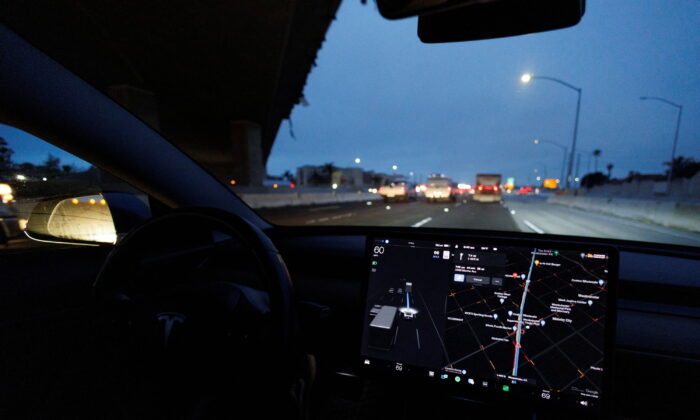 A Tesla Model 3 vehicle drives on autopilot along the 405 highway in Westminster, Calif. on March 16, 2022. (Mike Blake/Reuters)