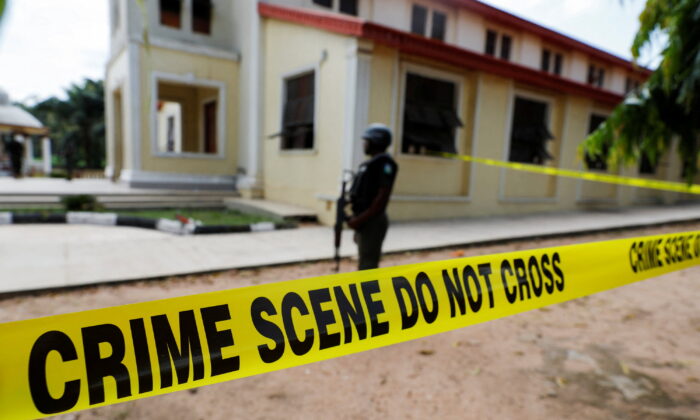 Police crime scene tape in front of St. Francis Catholic Church where gunmen attacked worshippers during a Sunday mass service in Owo, Ondo, Nigeria, on June 6, 2022. (Temilade Adelaja/Reuters)