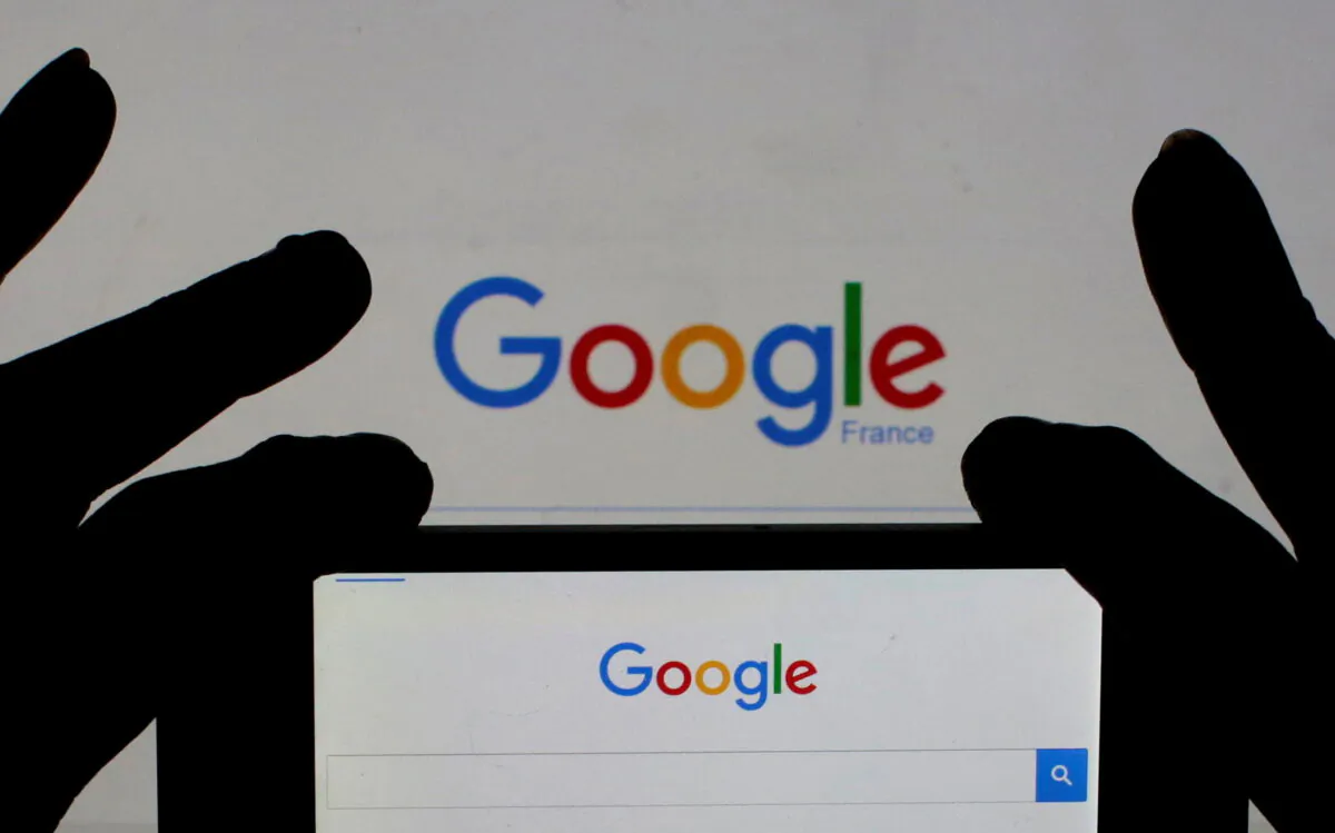 A woman holds her smart phone which displays the Google home page on Feb. 24, 2016. (Eric Gaillard/Reuters)