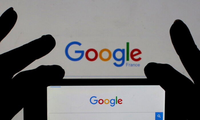 A woman holds her smart phone which displays the Google home page on Feb. 24, 2016. (Eric Gaillard/Reuters)