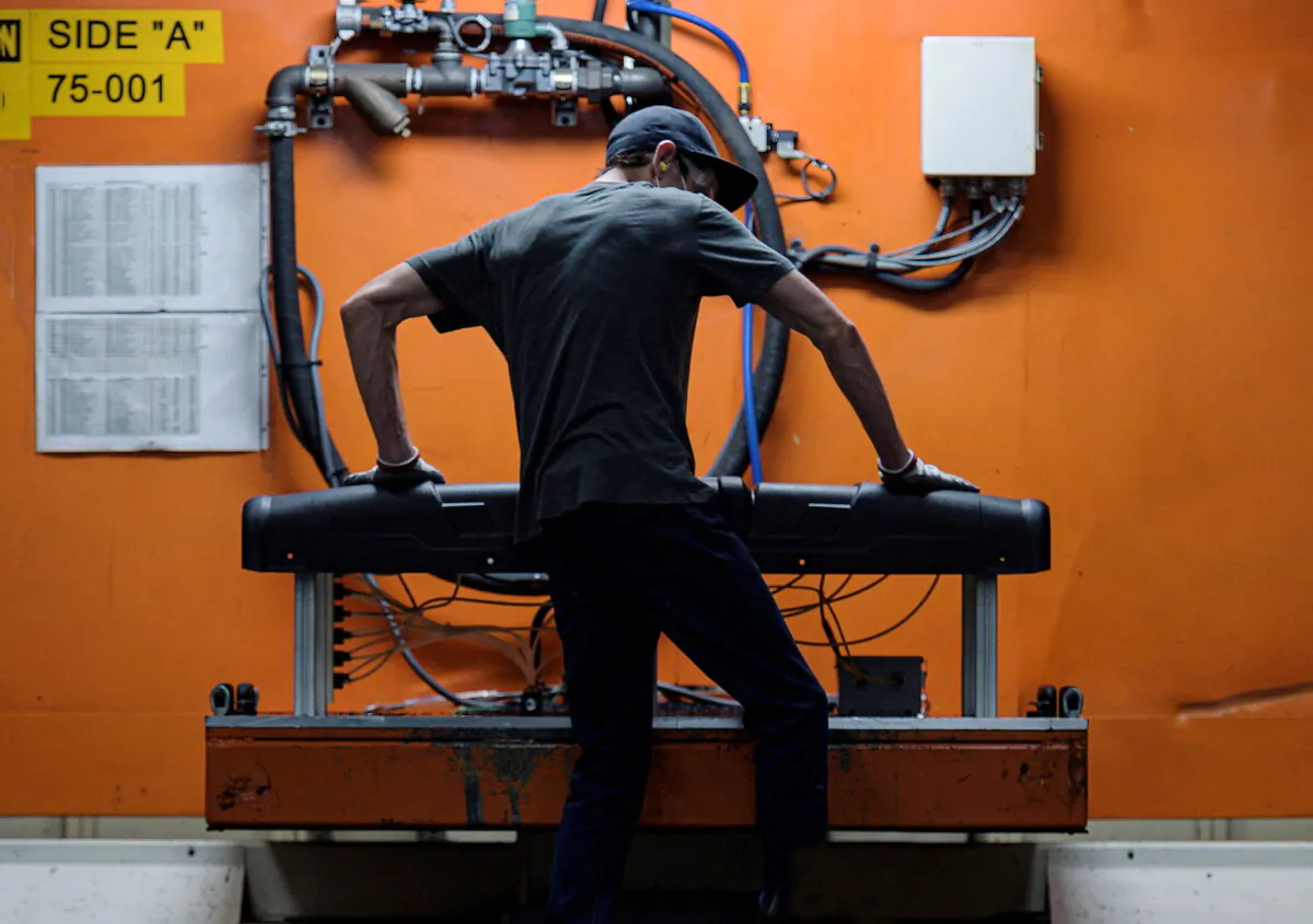 A person works at an injection molding station at the Polaris manufacturing and assembly plant in Roseau, Minn., on June 7, 2021. (Dan Koeck/Files/Reuters)