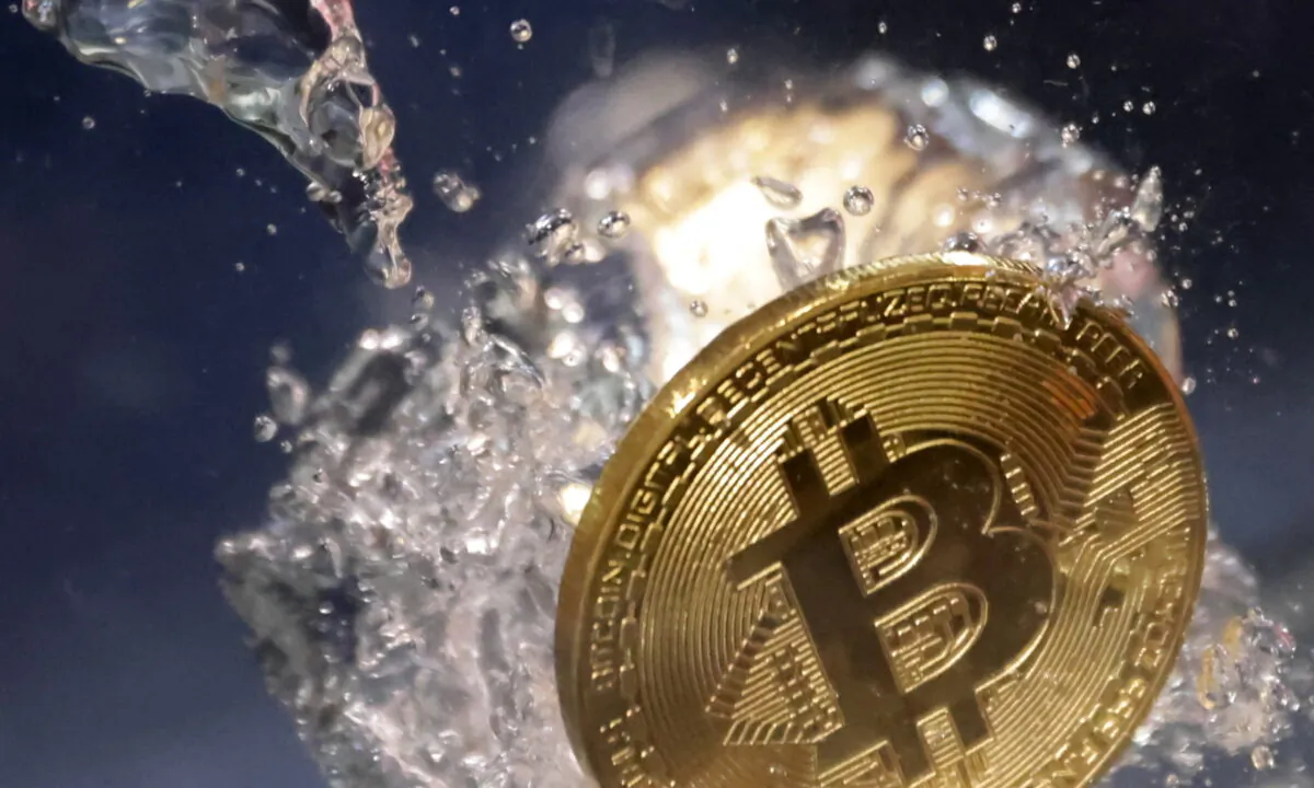 Cryptocurrency Bitcoin plunging into water, on May 23, 2022. (Dado Ruvic/Illustration/Reuters)