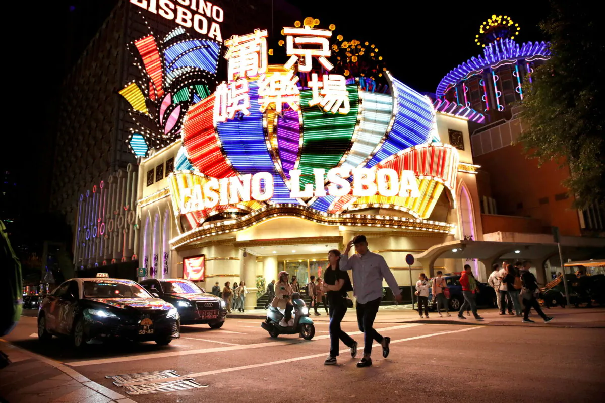 People walk in front of Casino Lisboa in Macau on Dec. 21, 2019. (Jason Lee/Reuters)