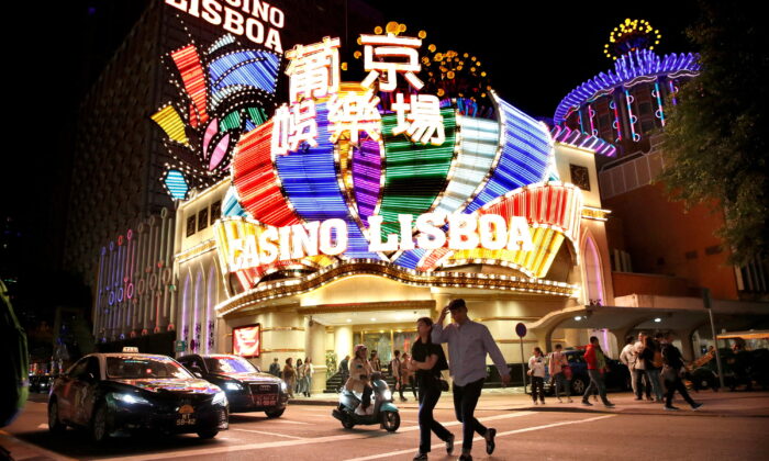 People walk in front of Casino Lisboa in Macau on Dec. 21, 2019. (Jason Lee/Reuters)