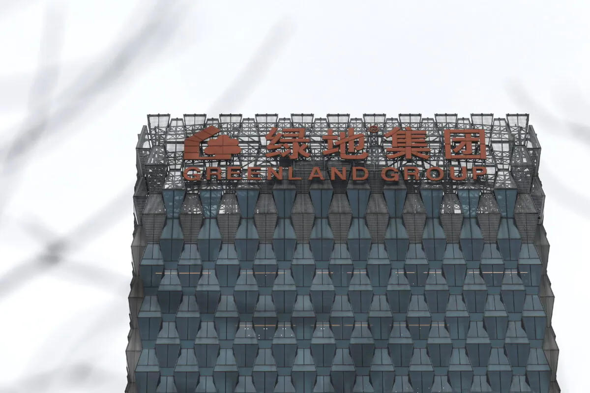 A sign of Greenland Holdings Corp. Ltd. on its building in Beijing on March 11, 2022. (Tingshu Wang/Reuters)