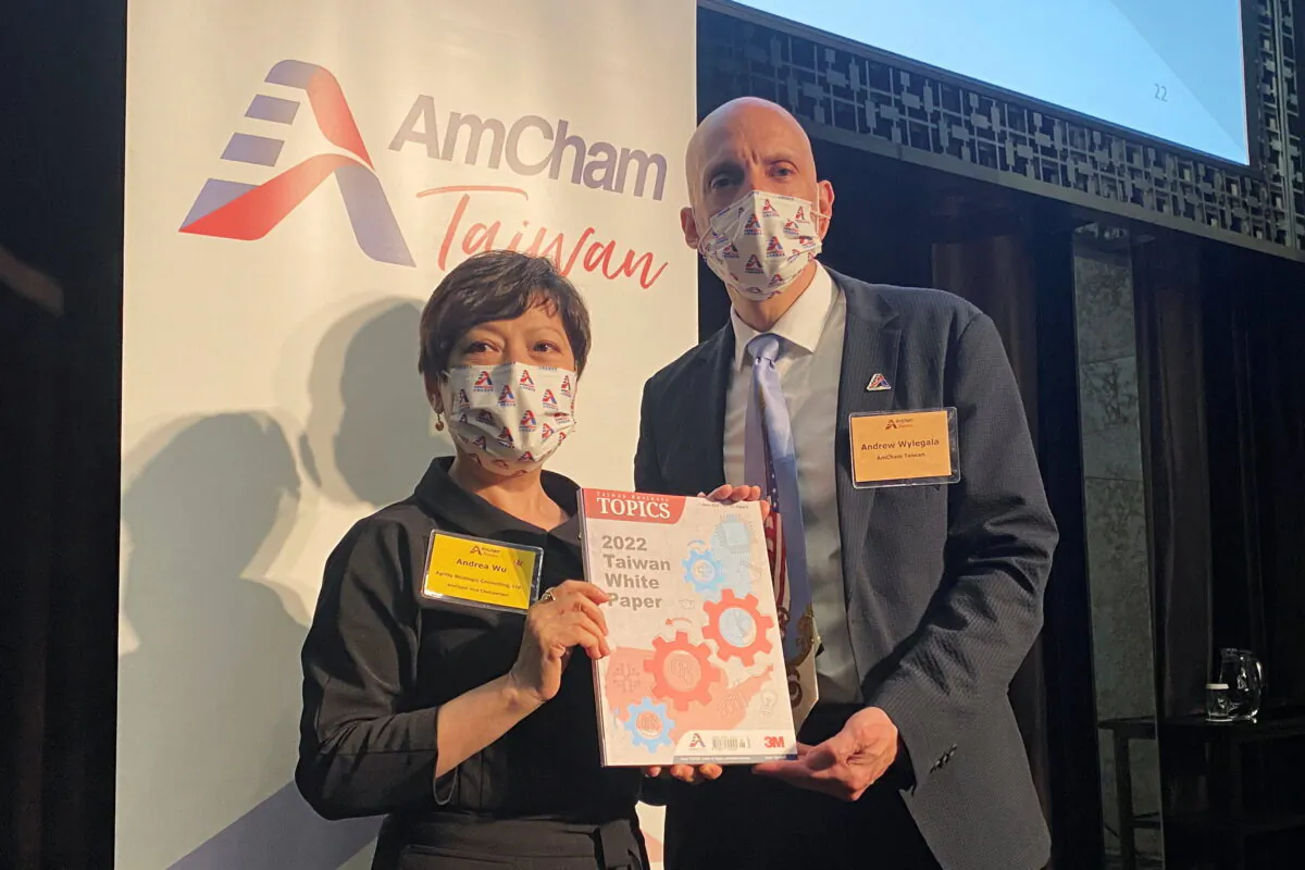 AmCham Taiwan Vice Chairperson Andrea Wu (L) and President Andrew Wylegala pose with a copy of the 2022 White Paper by the American Chamber of Commerce in Taiwan, in Taipei, Taiwan on June 22, 2022. (Ben Blanchard/Reuters)