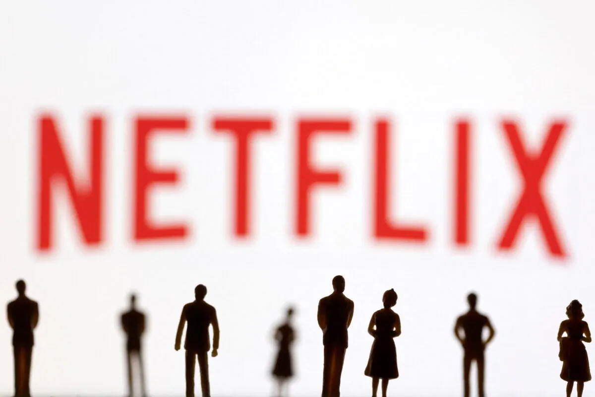 Toy figures of people are seen in front of the displayed Netflix logo, in this illustration taken on Jan. 20, 2022. (Dado Ruvic/Illustration/Reuters)