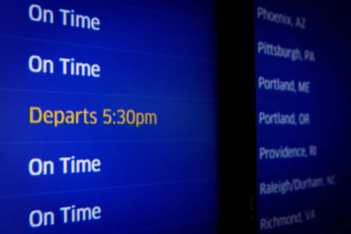 A screen displays flight status at O'Hare International Airport ahead of the Thanksgiving holiday in Chicago, Ill., on Nov. 20, 2021. (Brendan McDermid/Reuters)