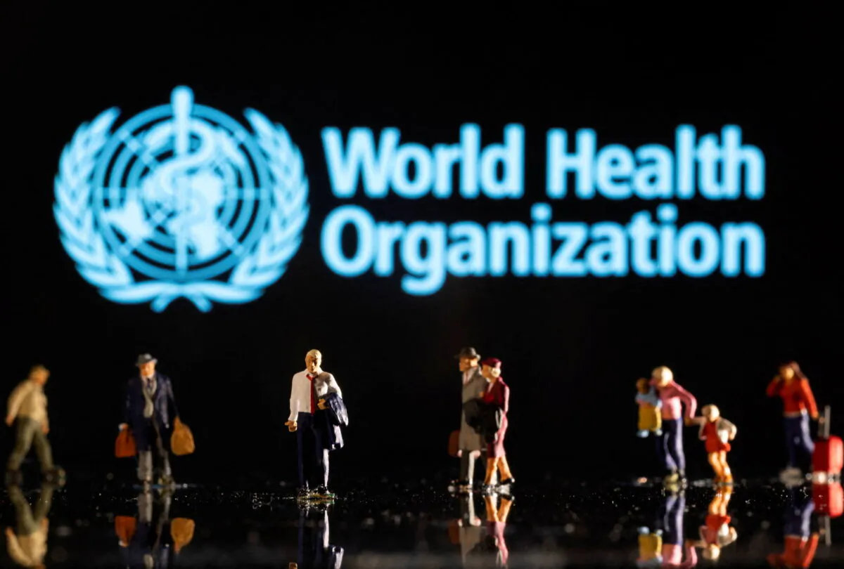 Small figurines are seen in front of the World Health Organization logo in this illustration taken on Febr. 11, 2022. (Dado Ruvic/Reuters)