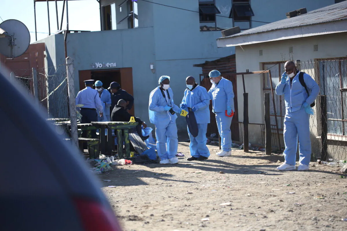 Forensic personnel investigate after the deaths of patrons found inside the Enyobeni Tavern, in Scenery Park, outside East London in the Eastern Cape Province, South Africa, on June 26, 2022. (Stringer/Reuters)