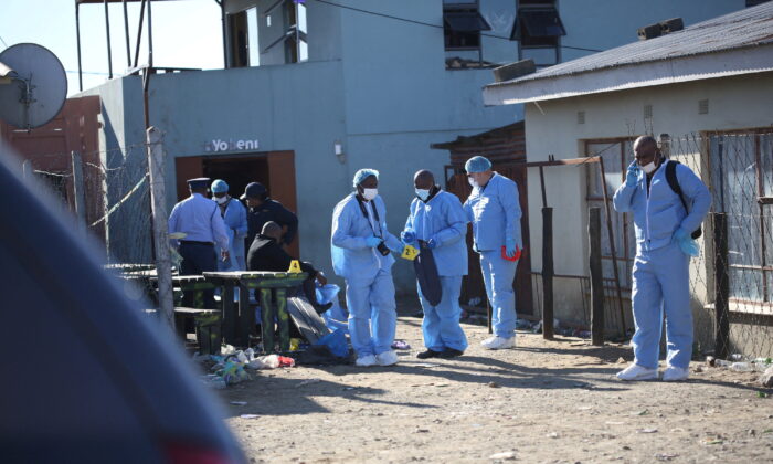 Forensic personnel investigate after the deaths of patrons found inside the Enyobeni Tavern, in Scenery Park, outside East London in the Eastern Cape Province, South Africa, on June 26, 2022. (Stringer/Reuters)