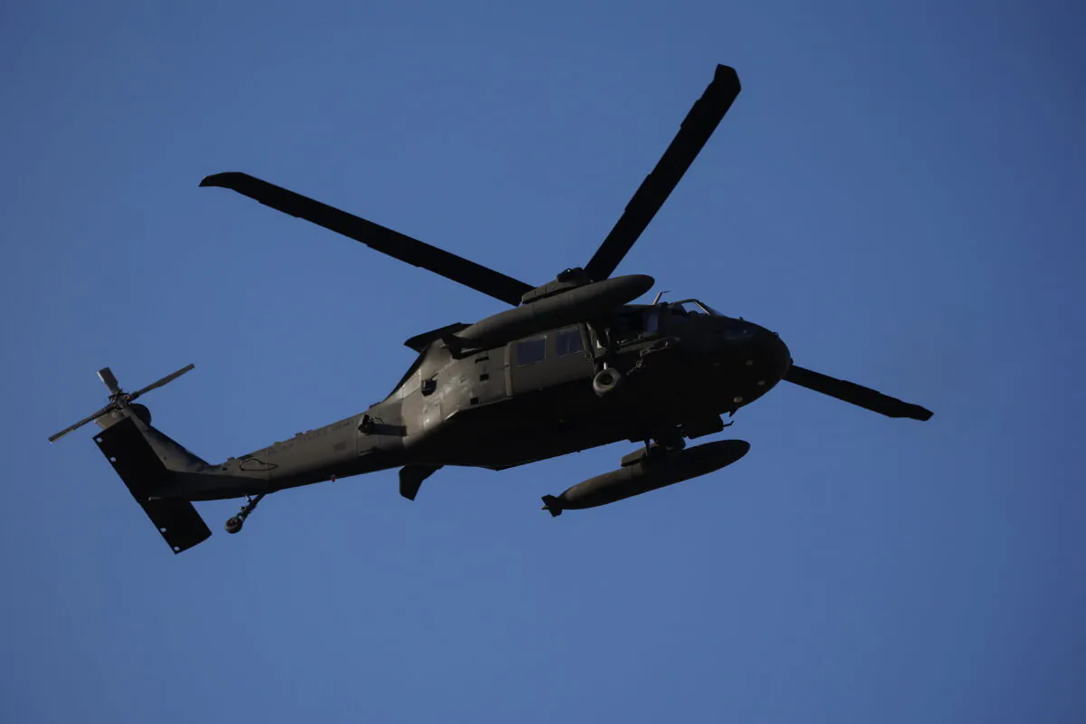 A U.S. Army Black Hawk helicopter flies over the Rzeszow-Jasionka Airport as President Joe Biden also arrives to visit Poland, near Rzeszow, Poland, on March 25, 2022. (Kacper Pempel/Reuters)