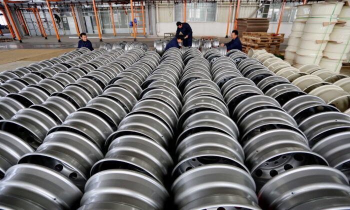 Workers arrange steel rims for export at a wheel factory in Lianyungang, Jiangsu province, China, on Nov. 22, 2017. (China Daily via Reuters)
