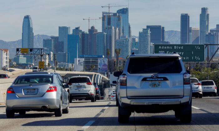 Traffic moves along a freeway in a file photo.  REUTERS/Mike Blake/File Photo