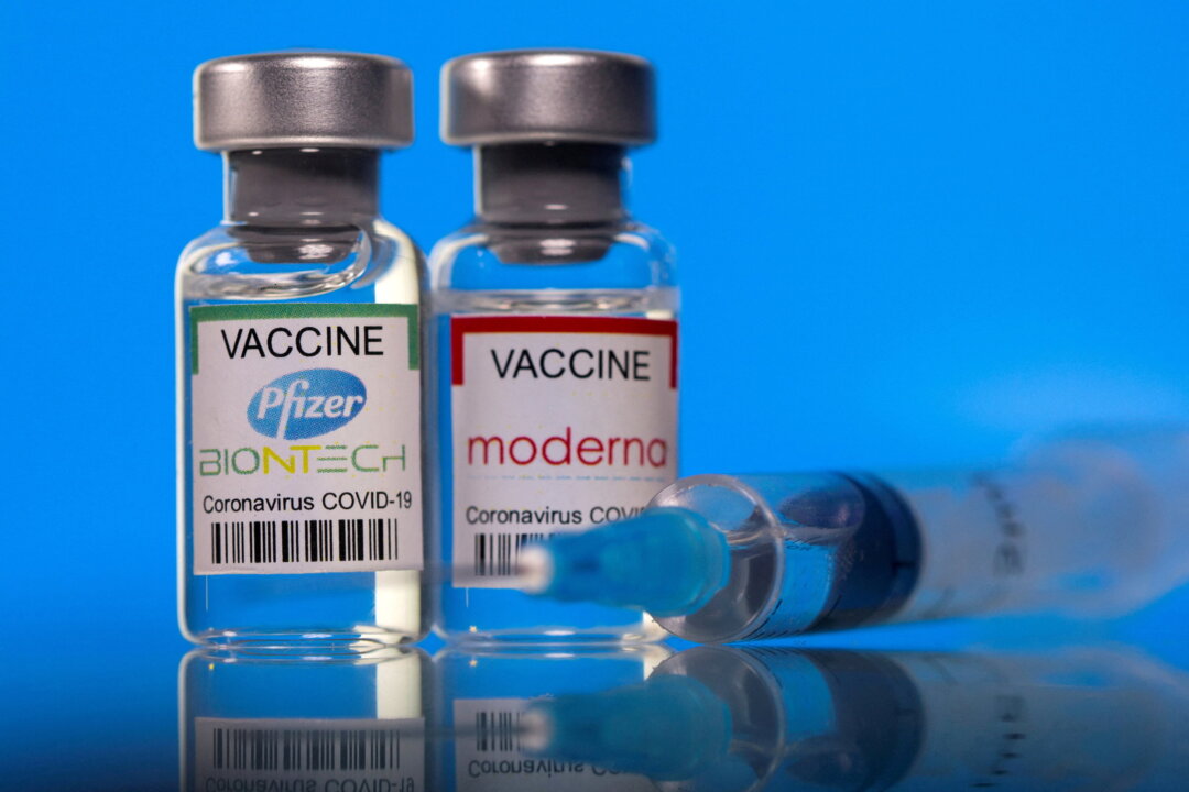 Vials with Pfizer-BioNTech and Moderna coronavirus disease (COVID-19) vaccine labels are seen in this illustration picture taken March 19, 2021. (Dado Ruvic//Reuters)