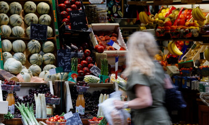 A woman shops at a fruit and vegetables shop in Paris, on June 10, 2022. (Sarah Meyssonnier/Reuters)