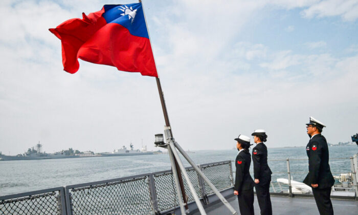 Taiwanese sailors salute the island's flag on the deck of the Panshih supply ship after taking part in annual drills, at the Tsoying naval base in Kaohsiung on Jan. 31, 2018. (Mandy Cheng/AFP via Getty Images)