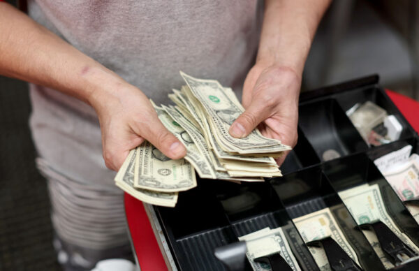 A man holds U.S. dollars.