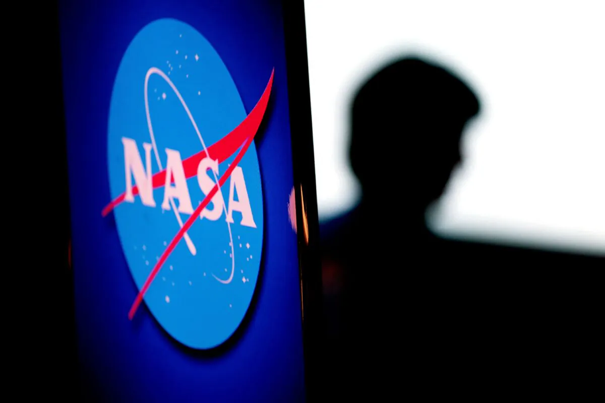 The silhouette of U.S. engineer and NASA astronaut Megan McArthur is seen past the space agency's logo in the Webb Auditorium at NASA headquarters in Washington on June 7, 2022. (Stefani Reynolds/via Getty Images)