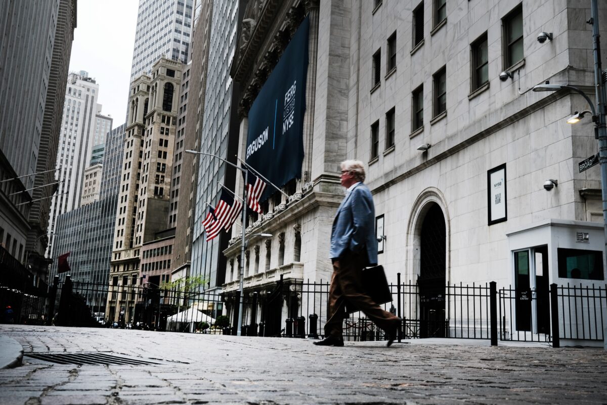 People walk by the New York Stock Exchange (NYSE) in New York City on May 12, 2022.(Spencer Platt/Getty Images)
