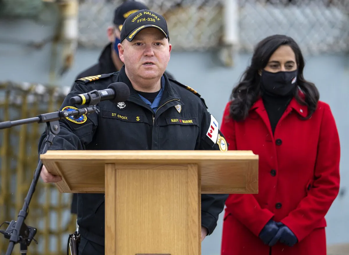 Cmdr. Dale St. Croix, commanding officer of HMCS Halifax delivers remarks as Defence Minister Anita Anand, right, look on as the frigate prepares to depart Halifax in support of NATO's deterrence measures in eastern Europe on March 19, 2022. (The Canadian Press/Andrew Vaughan)