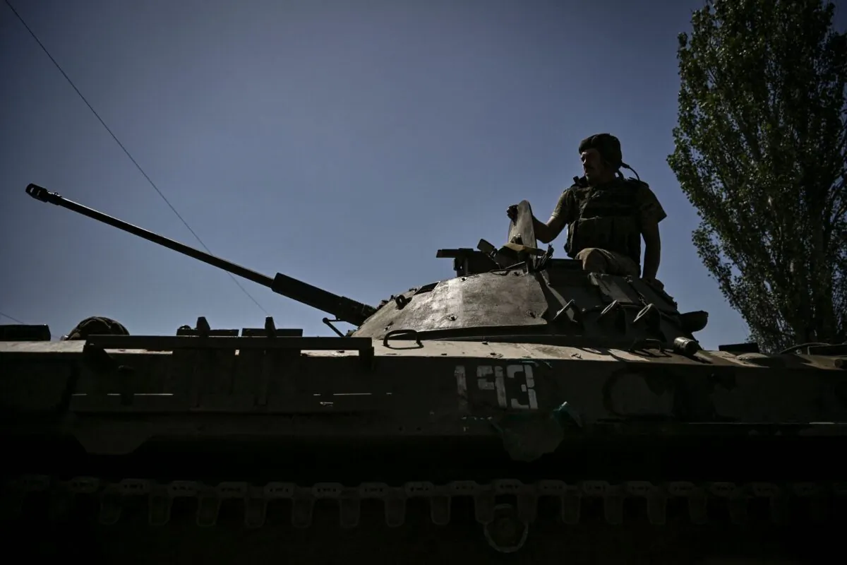 A member of the Ukrainian troops stands on an armoured vehicle moving towards the front line in the city of Lysychansk in the eastern Ukraine region of Donbass, on June 9, 2022. (Aris Messinis/AFP via Getty Images)