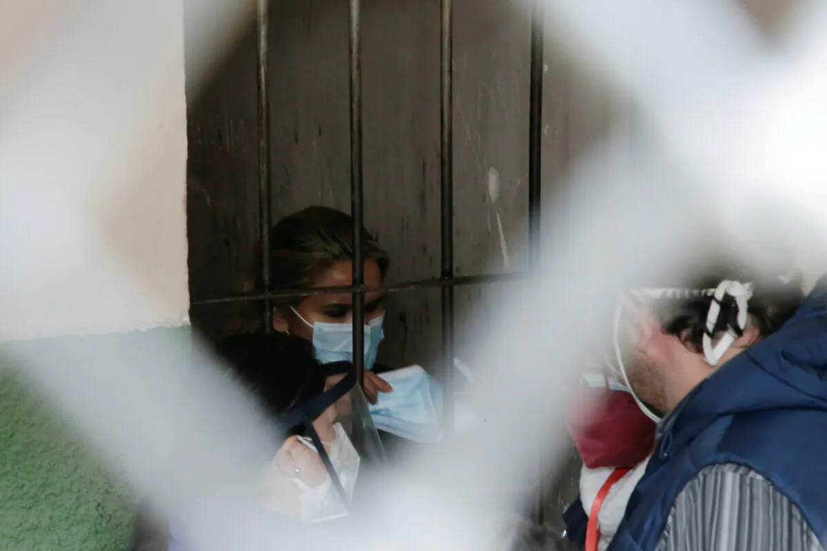 Bolivia's former interim President Jeanine Anez holds a mask as she is detained at a FELCC (Special Force to fight against Crime) prison in La Paz, Bolivia, on March 13, 2021. (David Mercado/Reuters)