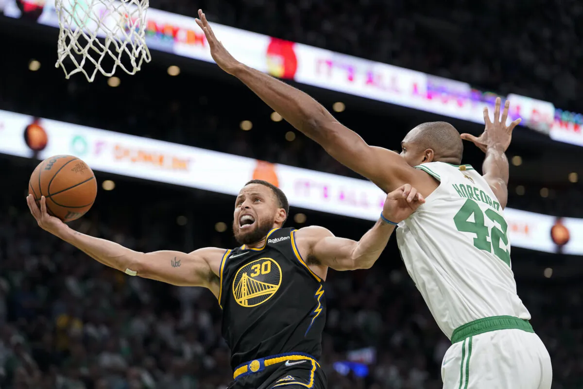 Golden State Warriors guard Stephen Curry (30) goes up for a shot against Boston Celtics center Al Horford (42) during the fourth quarter of Game 4 of basketball's NBA Finals in Boston on June 10, 2022. (Steven Senne/AP Photo)