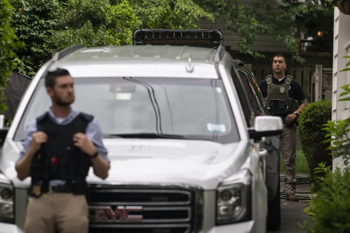 Law enforcement officers stand guard as protesters march past Supreme Court Justice Brett Kavanaugh's home, in Chevy Chase, Md., on June 8, 2022. (Nathan Howard/Getty Images)