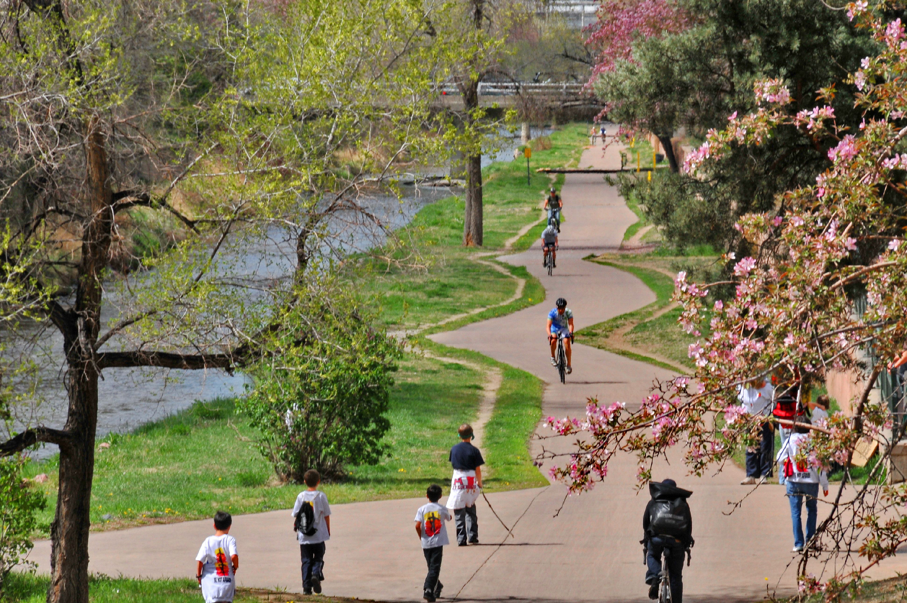 People walking and riding bokes in Cherry Creek Trail in Denver, Colorado