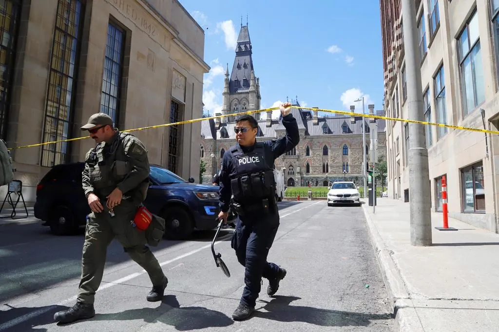 Police remove police tape after responding to an incident on Parliament Hill in Ottawa on June 11, 2022. (The Canadian Press/ Patrick Doyle)