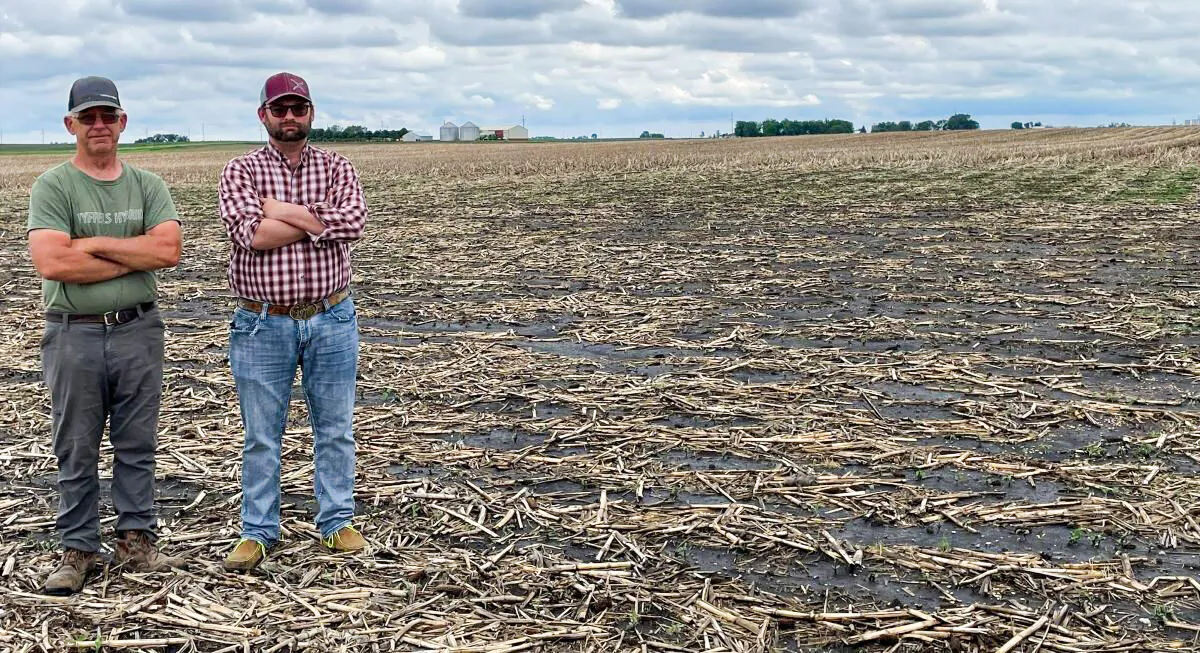 Allen Hayek, 66 and his son Austin Hayek, 36, Stand on their family’s Webster County, Iowa, farm where Summit Carbon Solutions aims to put an unwelcome carbon pipeline. (Courtesy Christine Hayek) 