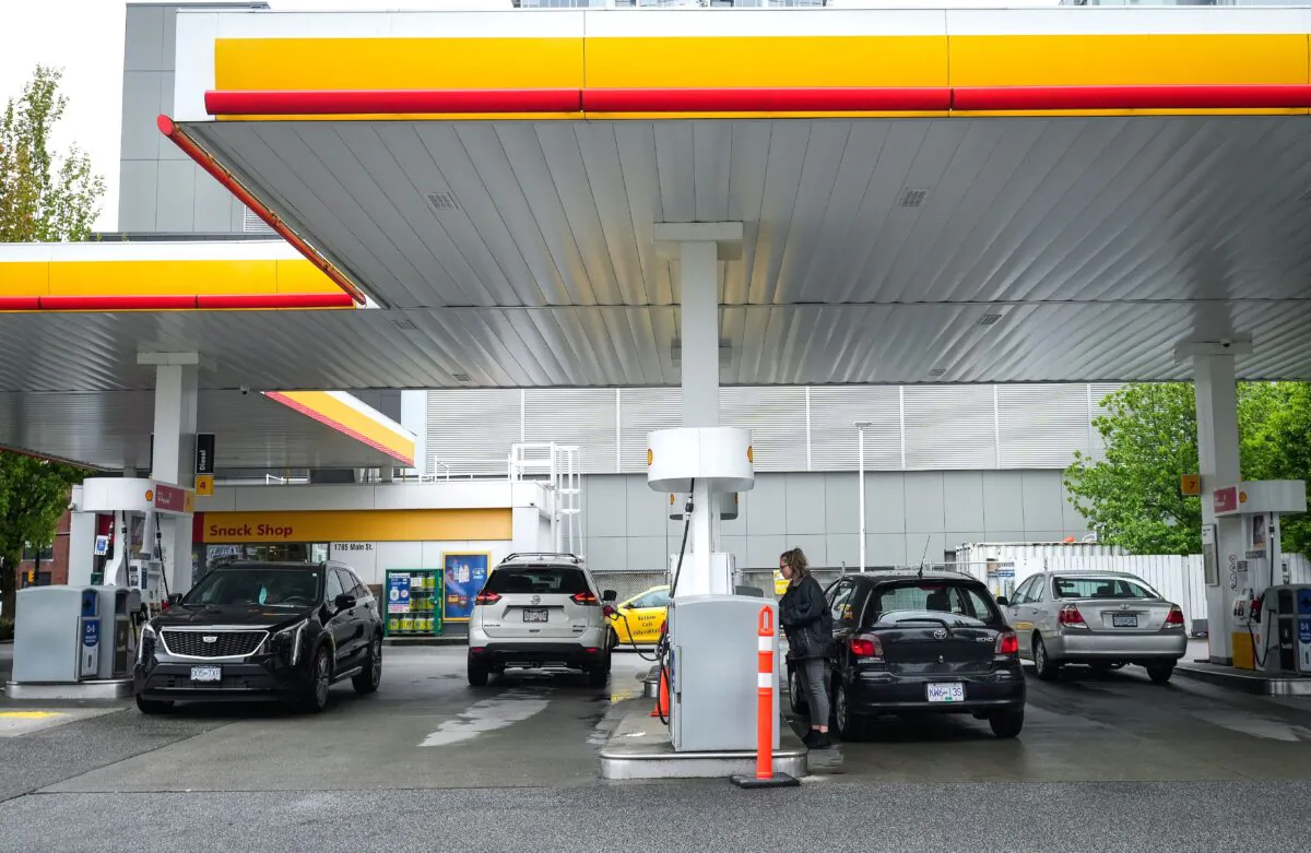 People fuel up their vehicles at a gas station in Vancouver after the price of a litre of regular-grade gasoline reached a new high of $2.28, on May 14, 2022. (The Canadian Press/Darryl Dyck)