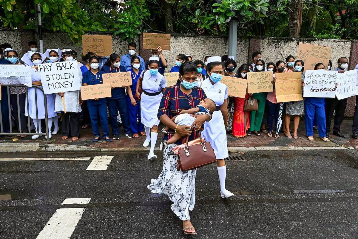 Doctors and nurses of the Lady Ridgeway Children's hospital hold placards during a silent demonstration against shortages of medicines in Colombo, Sri Lanka, on April 19, 2022. (Ishara S. Kodikara/AFP via Getty Images)