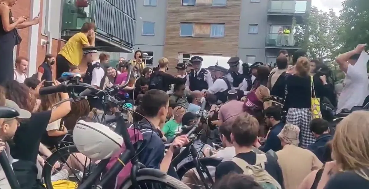 Protesters gather to prevent Home Office officers from taking away a man who had been arrested for immigration offences, in Peckham, southeast London, on June 11, 2022. (Handout photo issued by Eleanor Janega /PA Media)