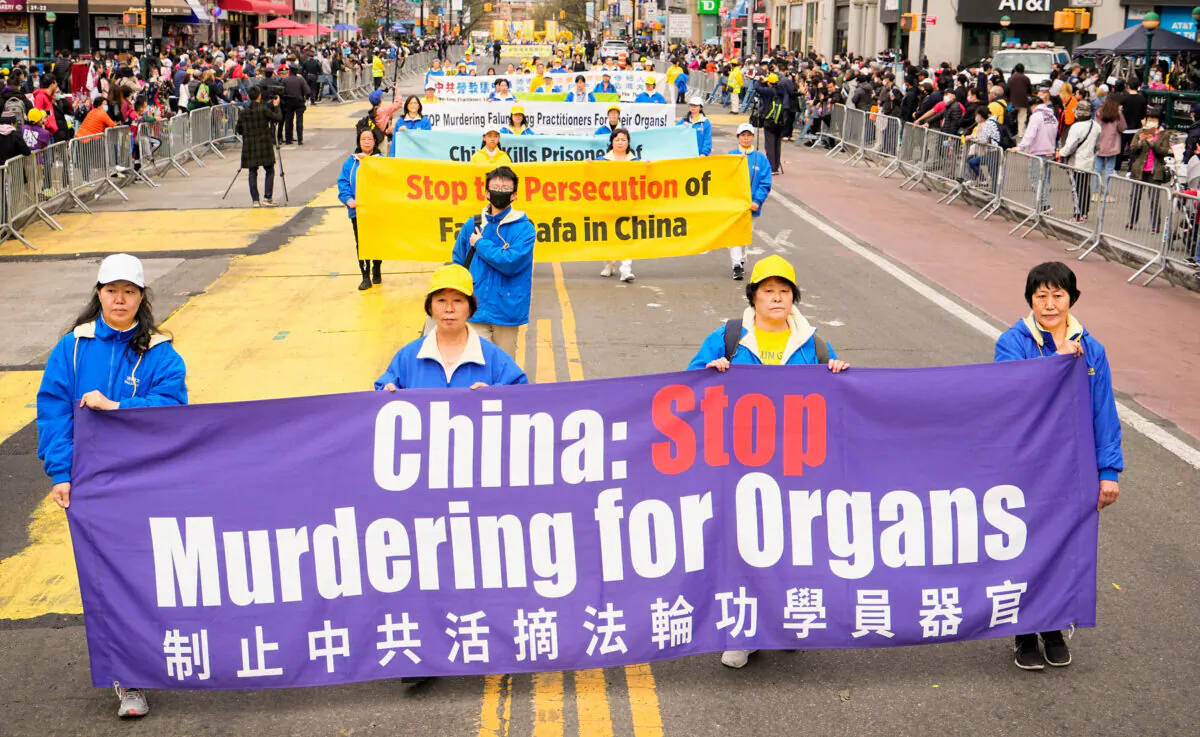 Falun Gong practitioners participate in a parade to commemorate the 23rd anniversary of the April 25th peaceful appeal of 10,000 Falun Gong practitioners in Beijing, in Flushing, N.Y., on April 23, 2022. (Larry Dye/The Epoch Times)